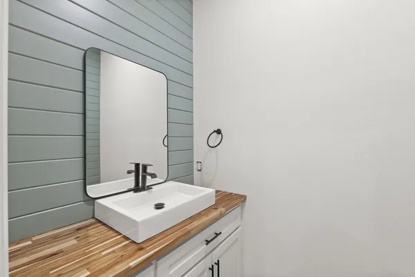 a white sink sitting under a bathroom next to a window