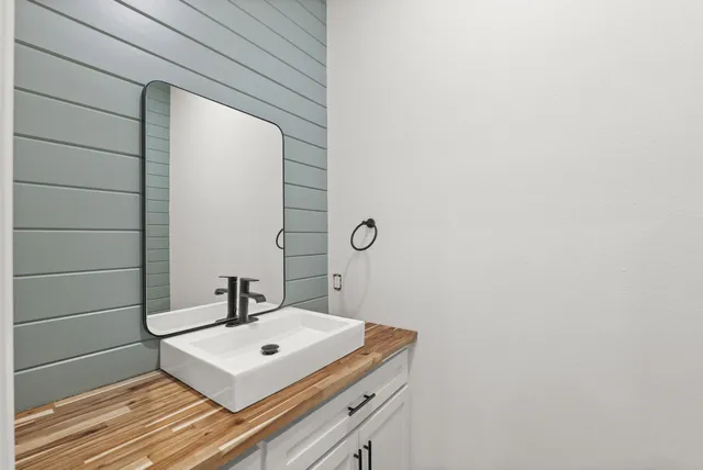 a white sink sitting under a bathroom next to a window