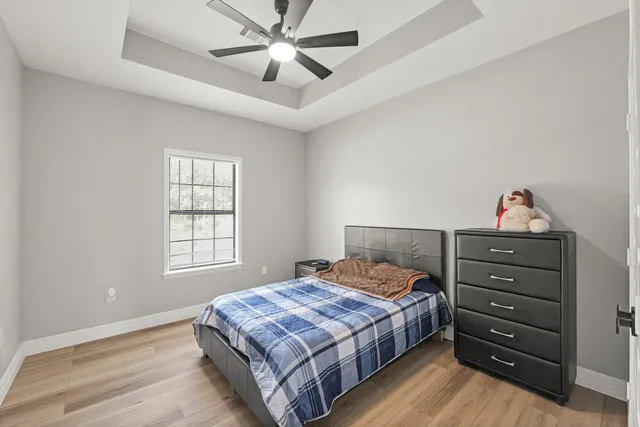 a bedroom with a bed and a chandelier