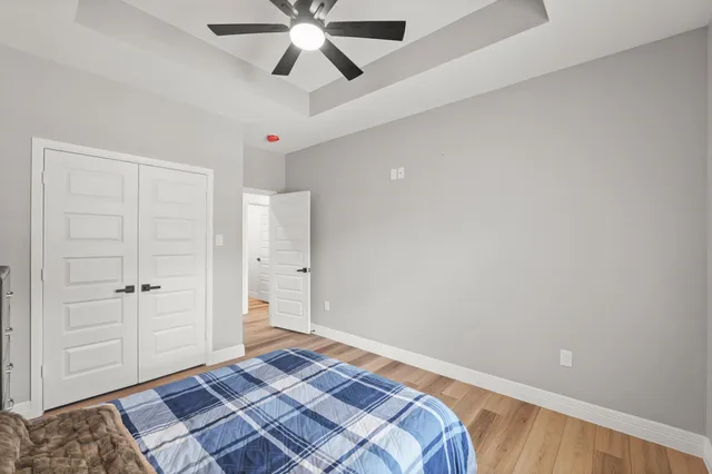 a bedroom with a bed and a ceiling fan