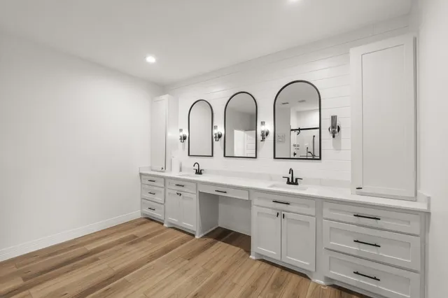 a view of cabinets with sink and wooden floor