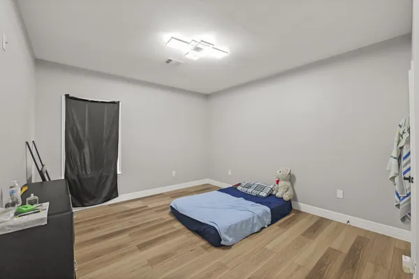 a view of a room with wooden floor and closet