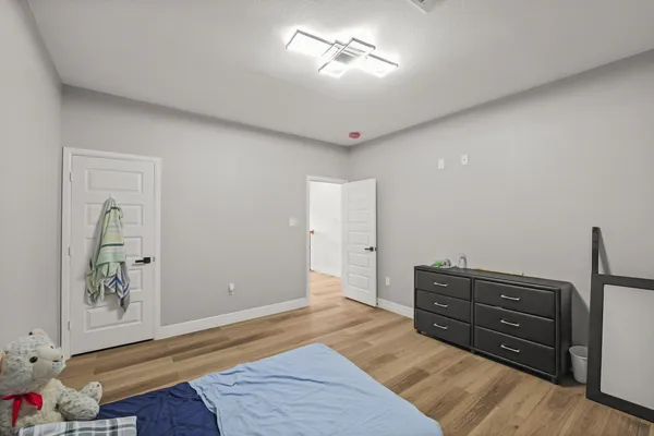 a view of room with furniture and wooden floor
