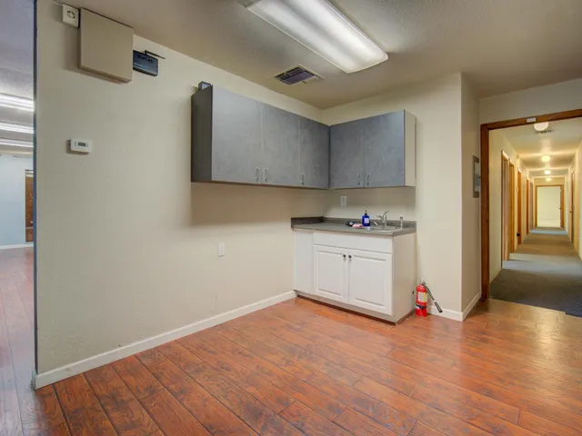 a kitchen with granite countertop a sink and a stove top oven