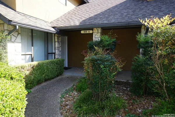 a front view of a house with plants