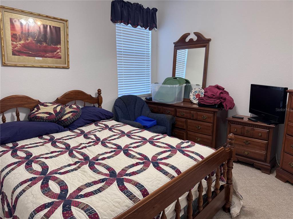 119 Hawthorne Road Auburndale, FL 33823 - Photo 18 of 26 a bedroom with two beds and a chandelier