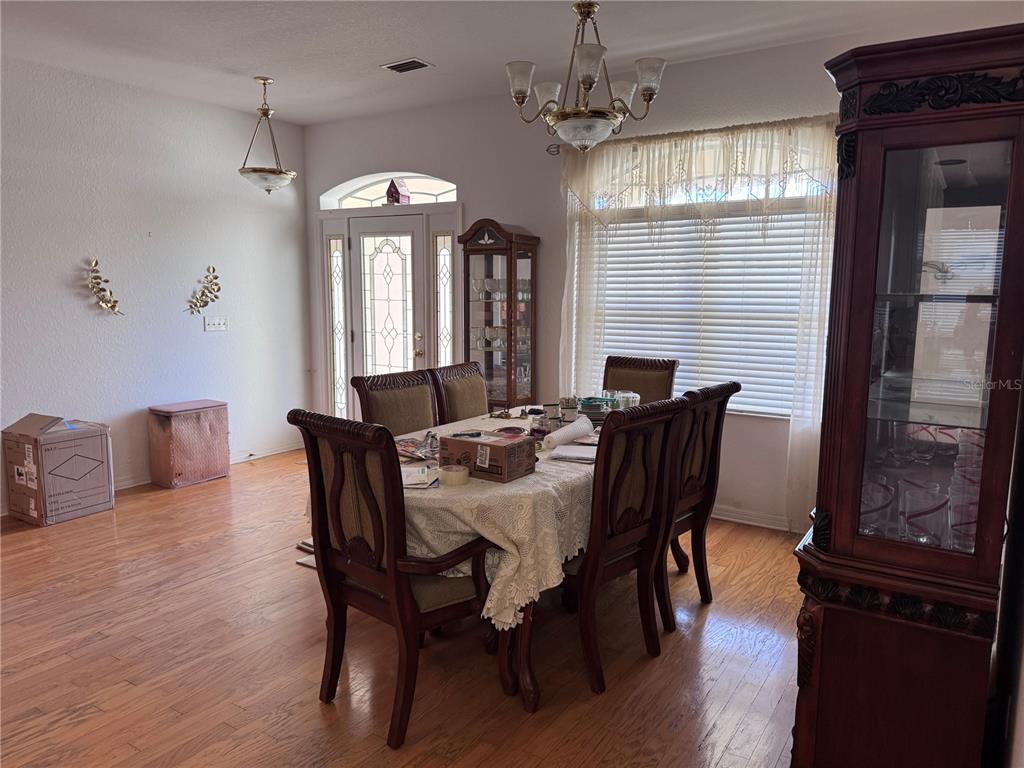 119 Hawthorne Road Auburndale, FL 33823 - Photo 7 of 26 a view of a dining room with furniture window and wooden floor