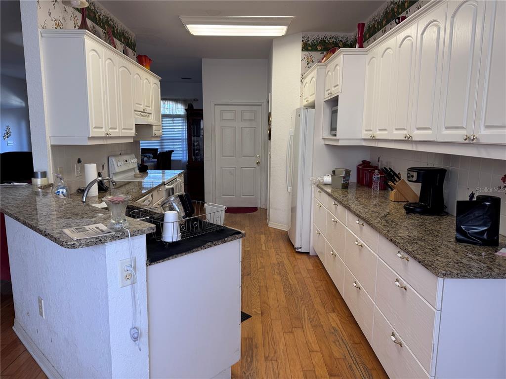 119 Hawthorne Road Auburndale, FL 33823 - Photo 8 of 26 a kitchen with stainless steel appliances granite countertop a sink stove and cabinets
