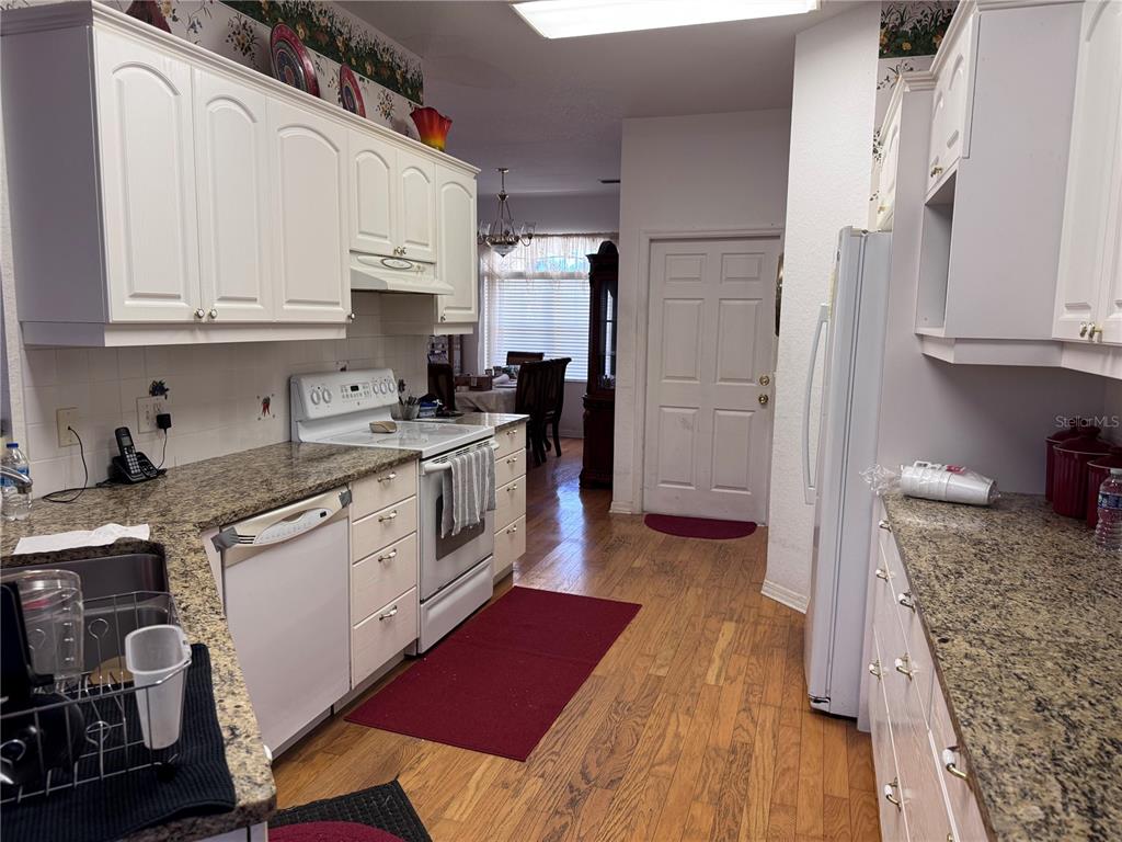 119 Hawthorne Road Auburndale, FL 33823 - Photo 9 of 26 a kitchen with a sink stove and cabinets
