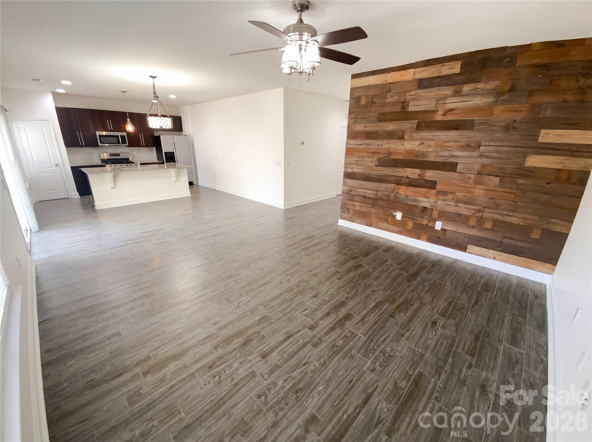 211 Waterlemon Way Monroe, NC 28110 - Photo 12 of 16 a view of a hallway with wooden floor and ceiling fan