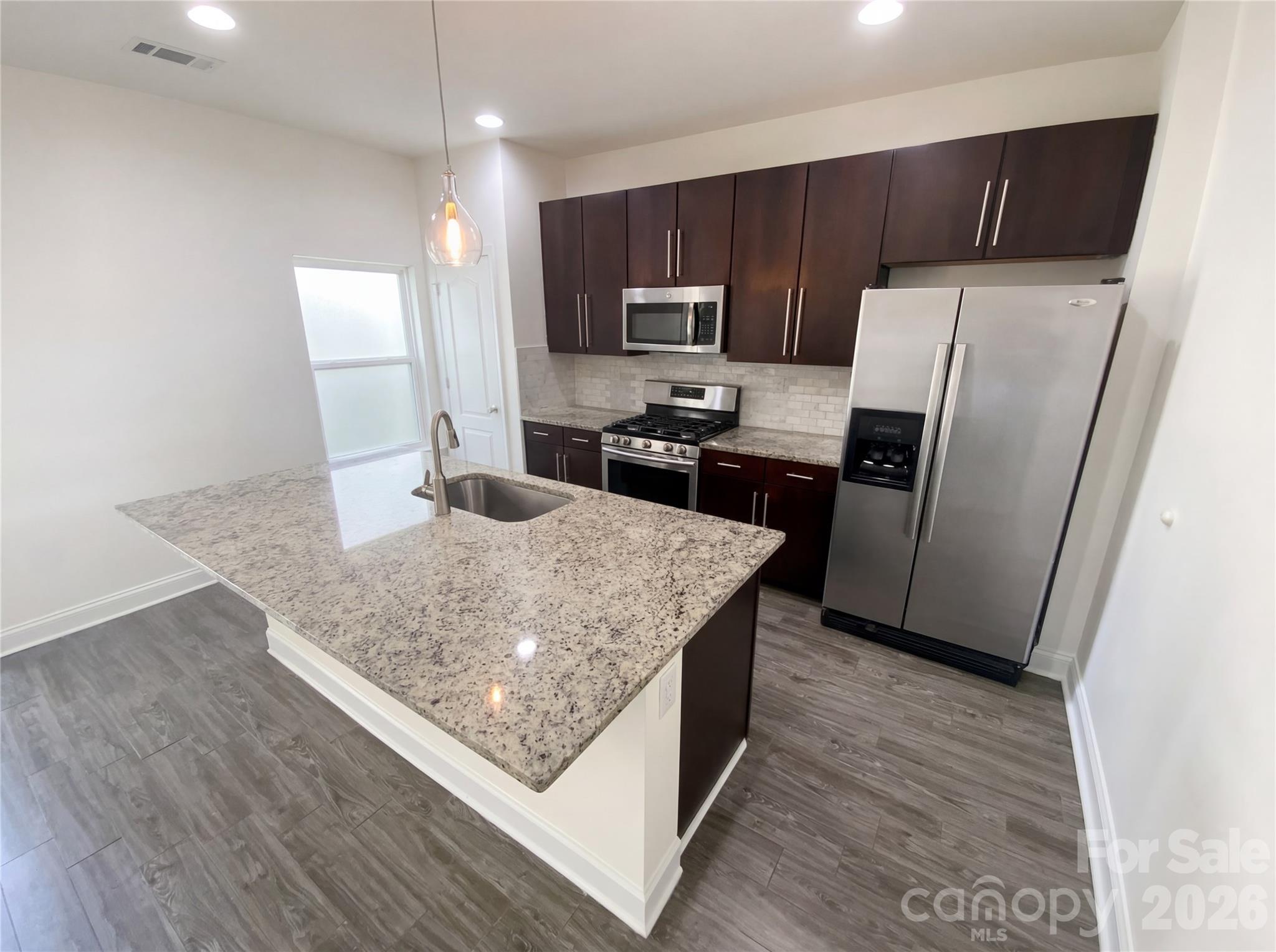 211 Waterlemon Way Monroe, NC 28110 - Photo 2 of 16 a kitchen with stainless steel appliances granite countertop a refrigerator a stove top oven a sink and dishwasher