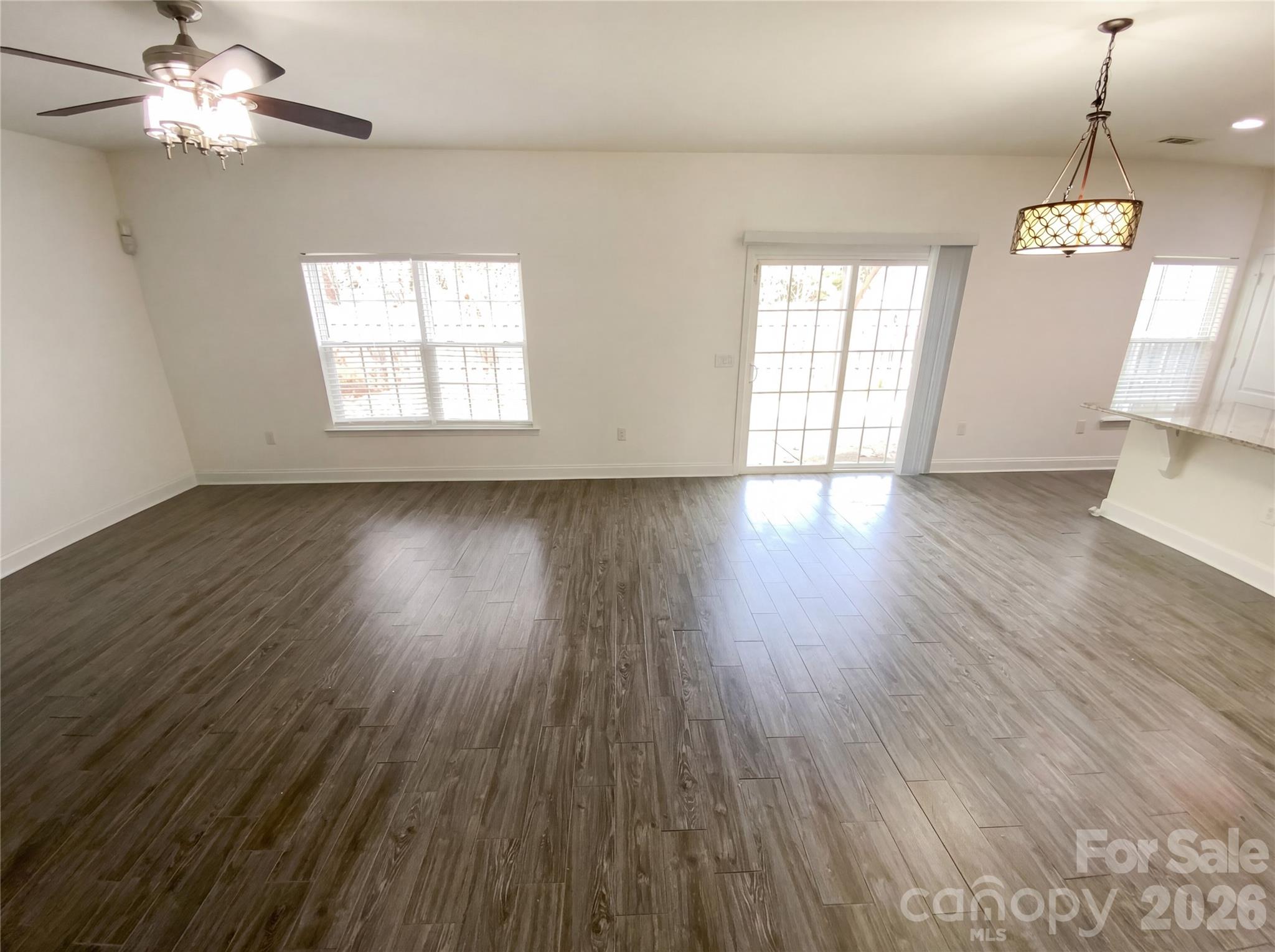 211 Waterlemon Way Monroe, NC 28110 - Photo 3 of 16 a view of an empty room with wooden floor and a window