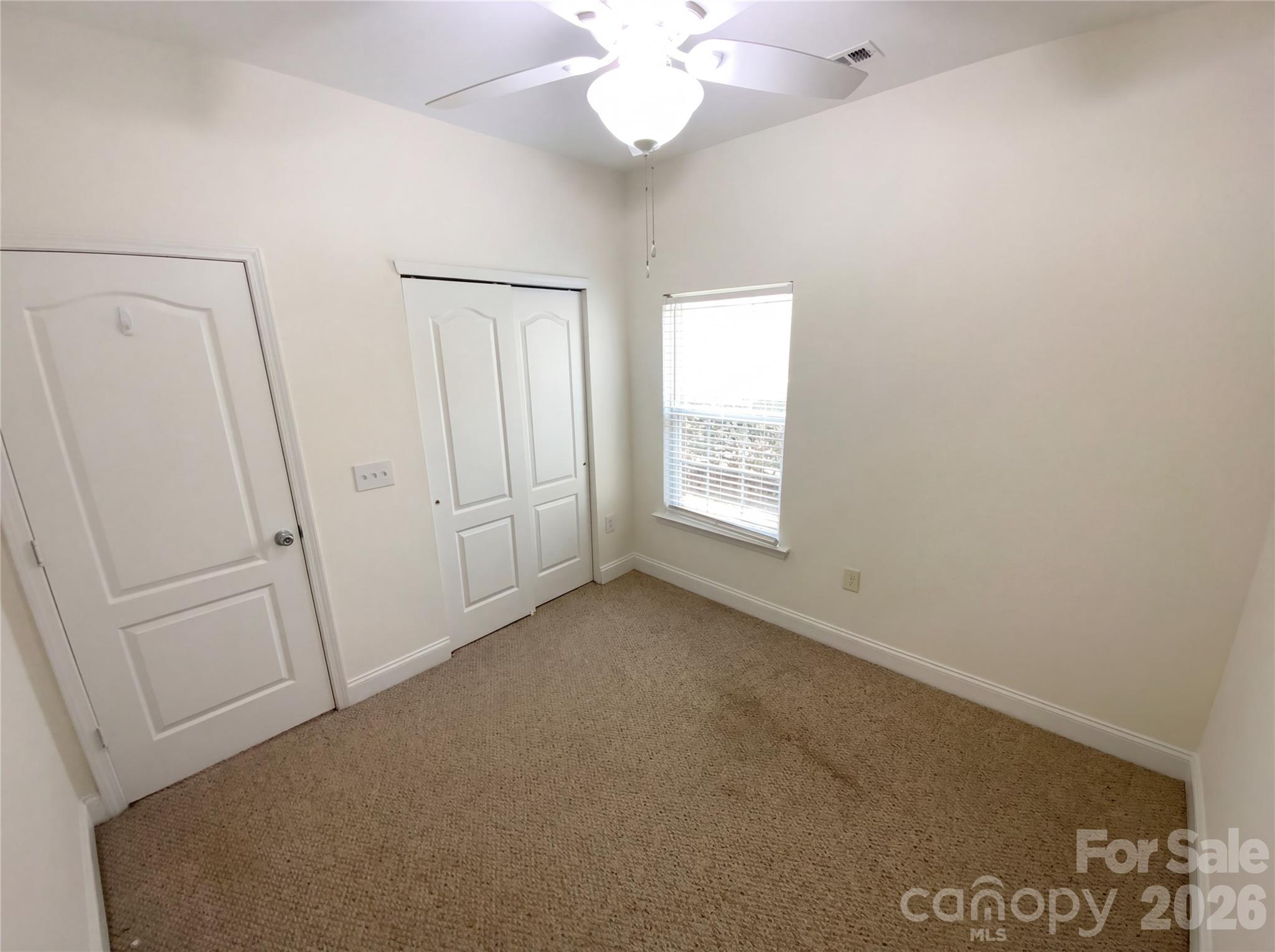 211 Waterlemon Way Monroe, NC 28110 - Photo 9 of 16 an empty room with windows and fan