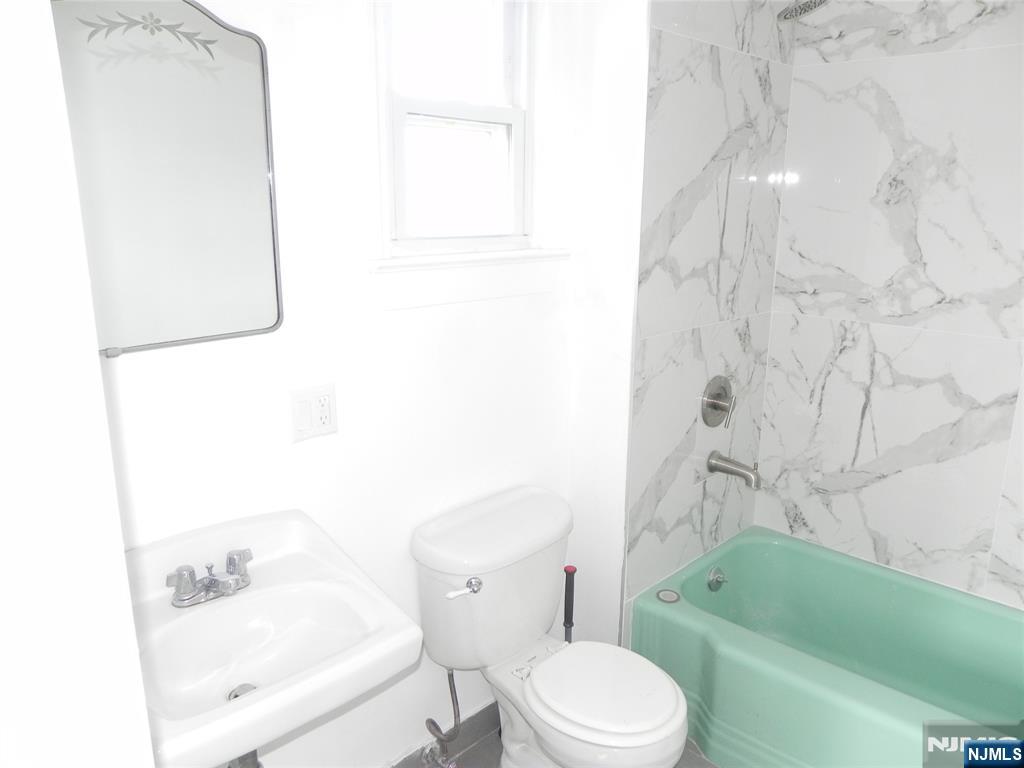 33 Center Street, Unit 1 Little Ferry, NJ 07643 - Photo 7 of 12 a bathroom with a toilet sink and bathtub