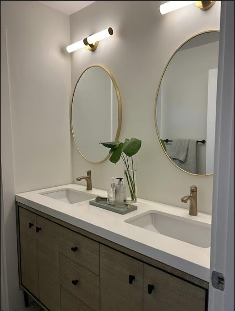 1822 Windsor Drive, Unit 1 Juno Ridge, FL 33408 - Photo 4 of 12 a bathroom with a sink and a mirror