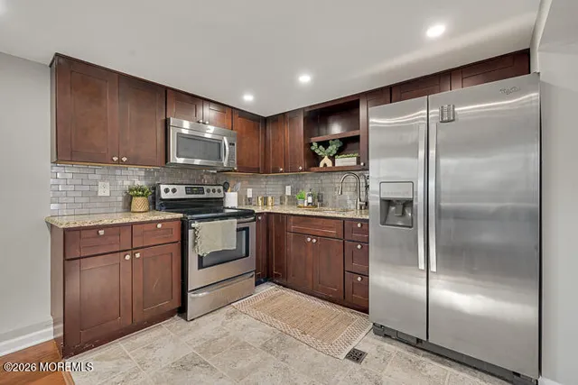 a kitchen with a refrigerator and a sink