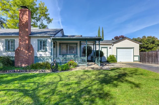 a front view of a house with garden and porch