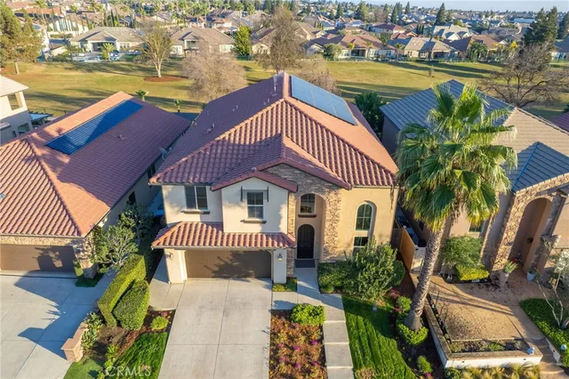 an aerial view of a house with a swimming pool patio and outdoor seating