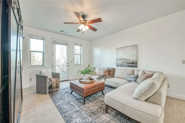 an empty room with closet and a chandelier fan