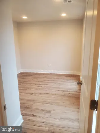 a view of room with wooden floor