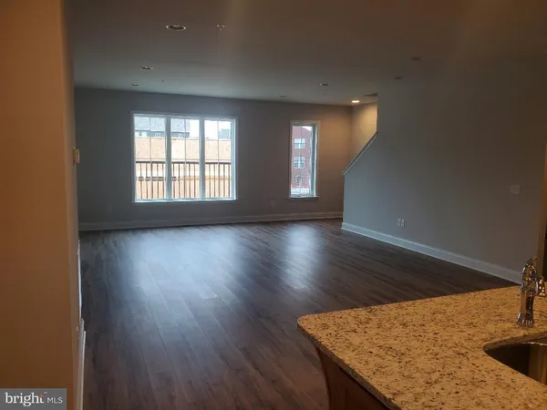 a view of wooden floor and windows in a room
