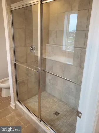a bathroom with a glass shower door