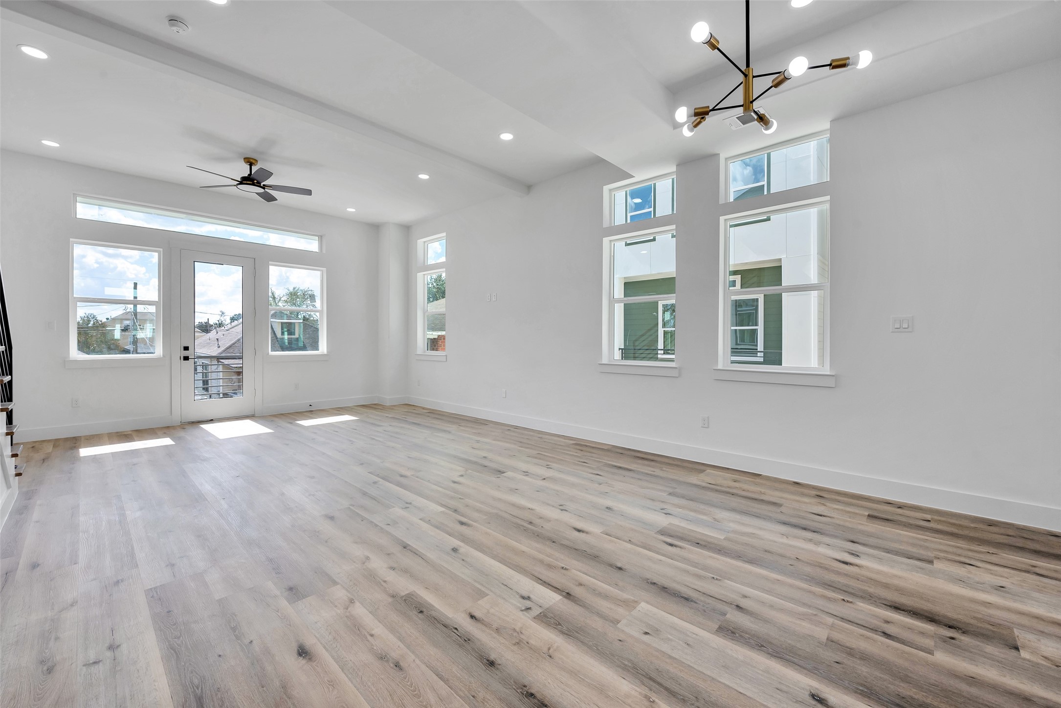 1805 Emir Street, Unit H Houston, TX 77009 - Photo 12 of 43 an empty room with wooden floor and windows