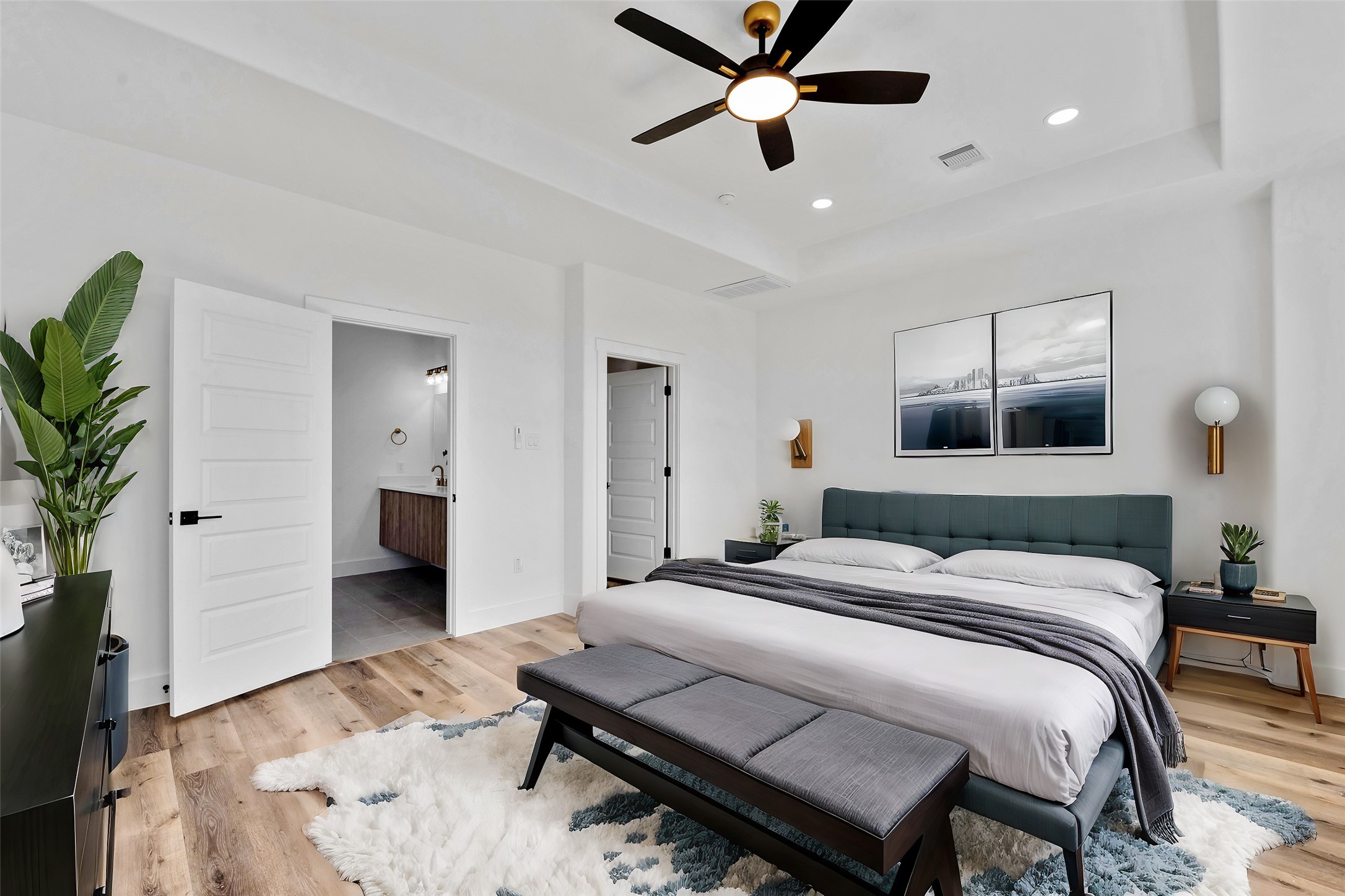 1805 Emir Street, Unit H Houston, TX 77009 - Photo 2 of 43 a bedroom with a bed and a potted plant on the dresser