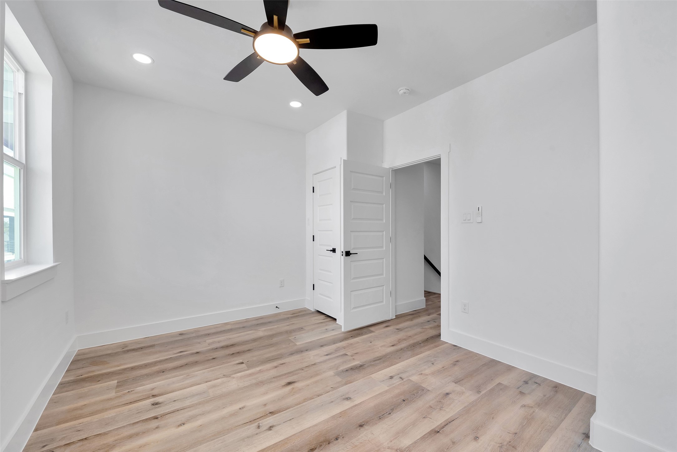 1805 Emir Street, Unit H Houston, TX 77009 - Photo 34 of 43 an empty room with wooden floor ceiling fan and windows