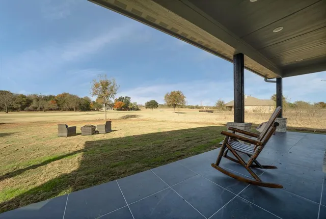 a view of swimming pool with outdoor seating space