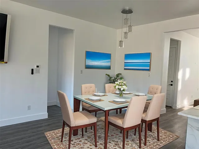 a view of a dining room with furniture and wooden floor