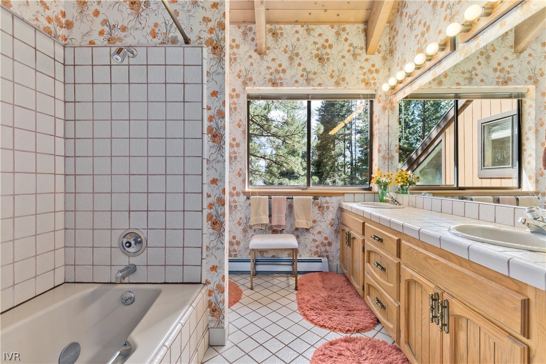 607 Crystal Peak Road Incline Village, NV 89451 - Photo 17 of 34 a bathroom with a granite countertop tub sink a mirror and a bathtub