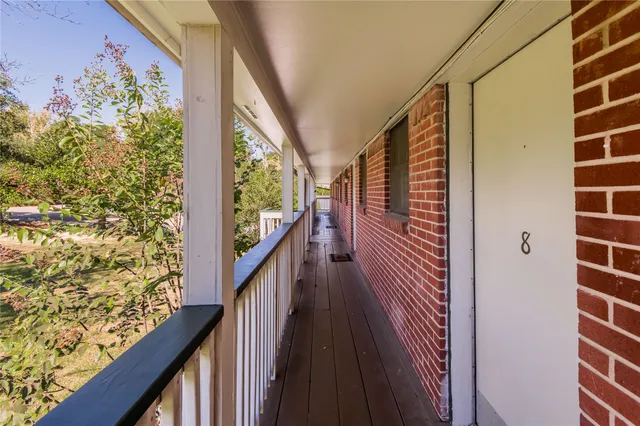 a view of a balcony and wooden floor
