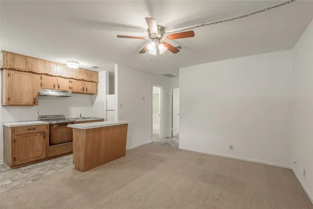 a kitchen with stainless steel appliances granite countertop a sink and a stove