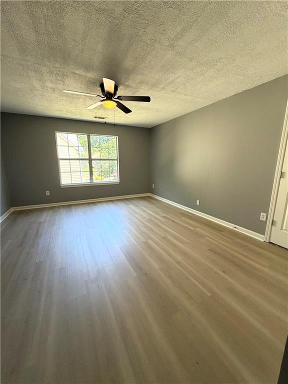 2205 Springer Walk Lawrenceville, GA 30043 - Photo 22 of 26 an empty room with wooden floor and windows