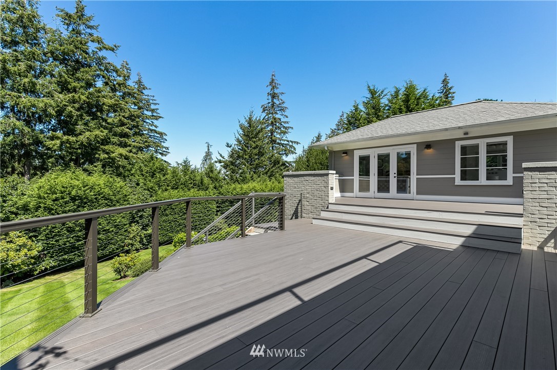 245 Middlefield Road Bellingham, WA 98225 - Photo 15 of 40 a balcony with wooden floor and potted plants