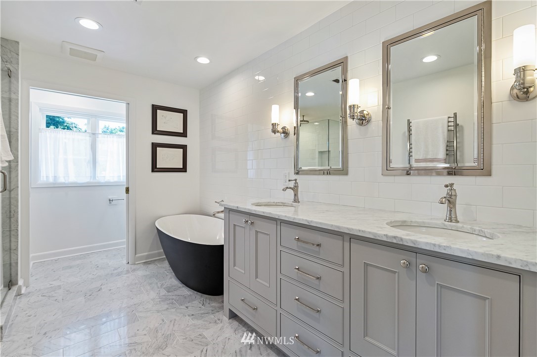 245 Middlefield Road Bellingham, WA 98225 - Photo 21 of 40 a spacious bathroom with a double vanity sink a large mirror and a bathtub