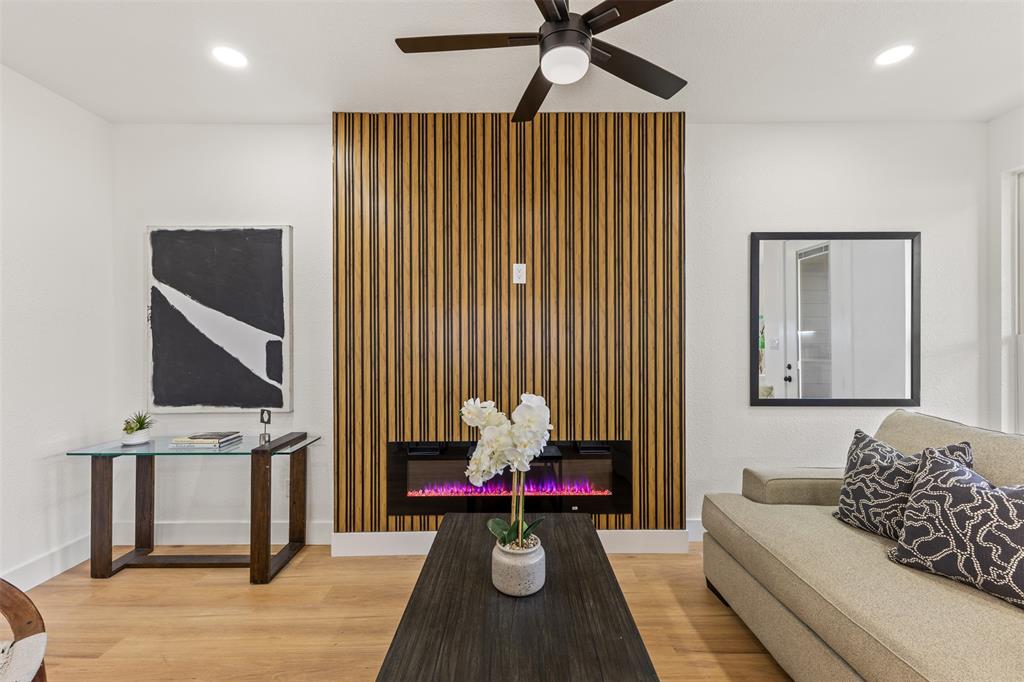 3526 Spring Avenue Dallas, TX 75210 - Photo 9 of 27 Living room featuring a glass covered fireplace, light wood finished floors, recessed lighting, and a ceiling fan