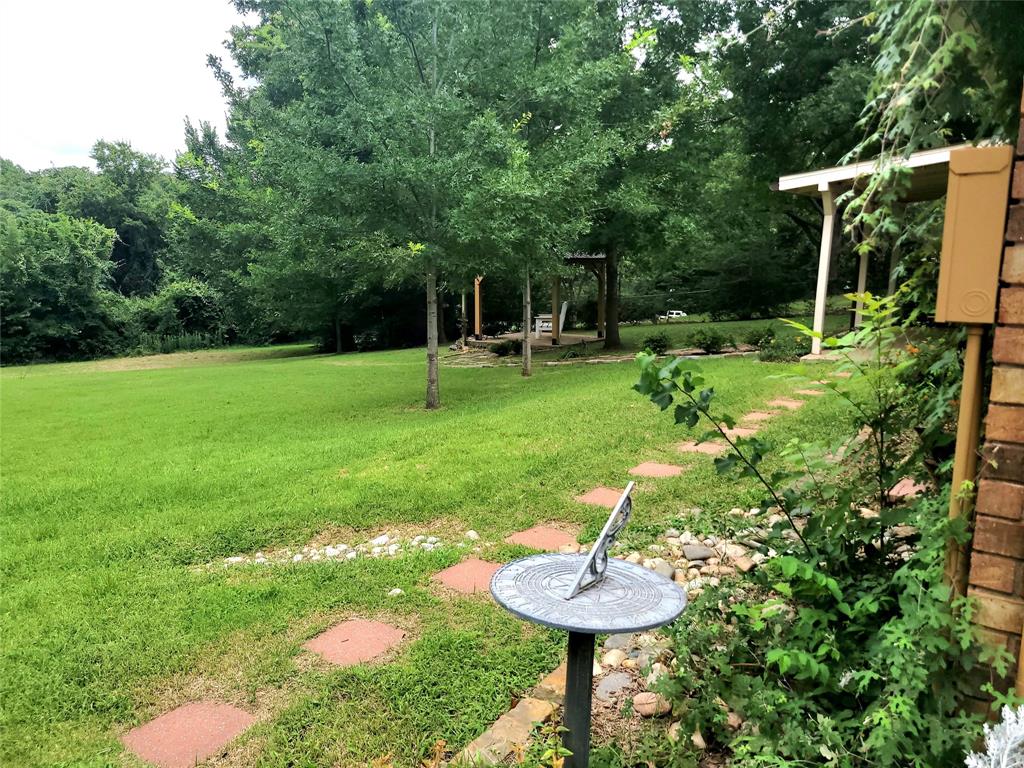 912 North Dove Road Grapevine, TX 76051 - Photo 32 of 36 a view of a backyard with table and chairs and potted plants with large trees