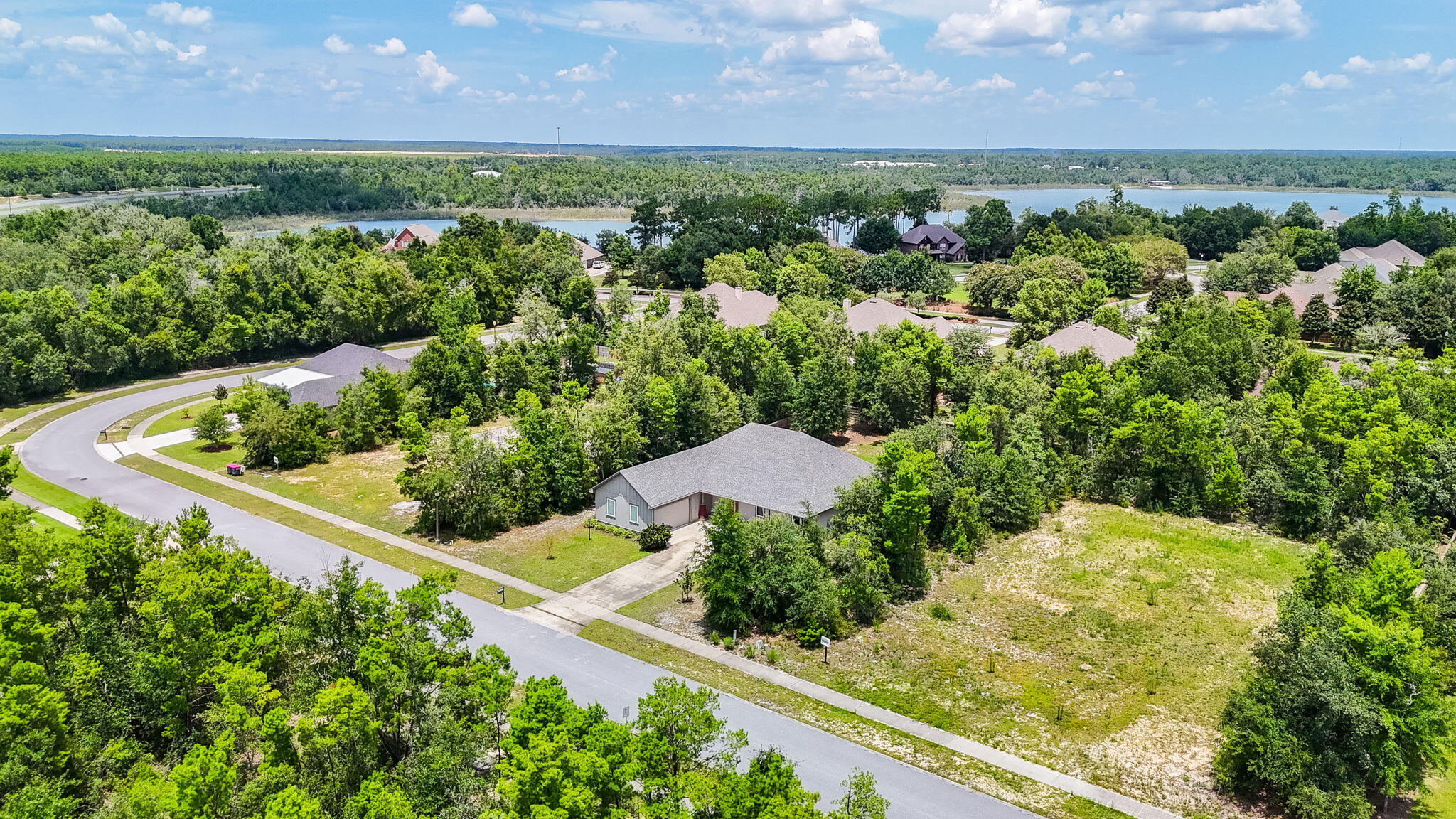 109 Lake Merial Trail Panama City, FL 32409 - Photo 3 of 12 an aerial view of a house with a yard and lake view