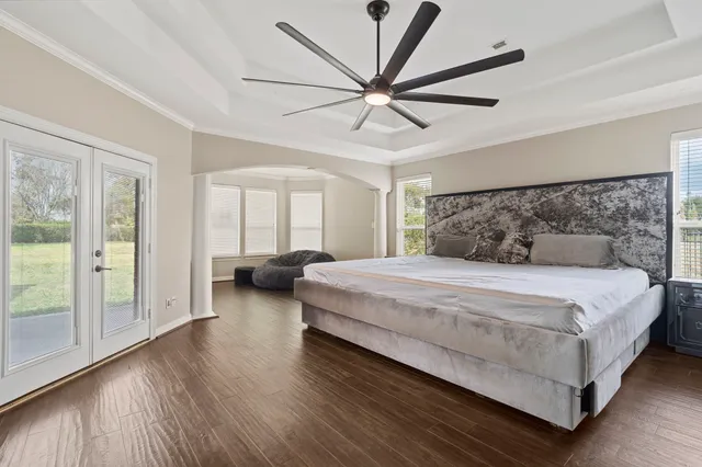 a bedroom with a large bed and a large window