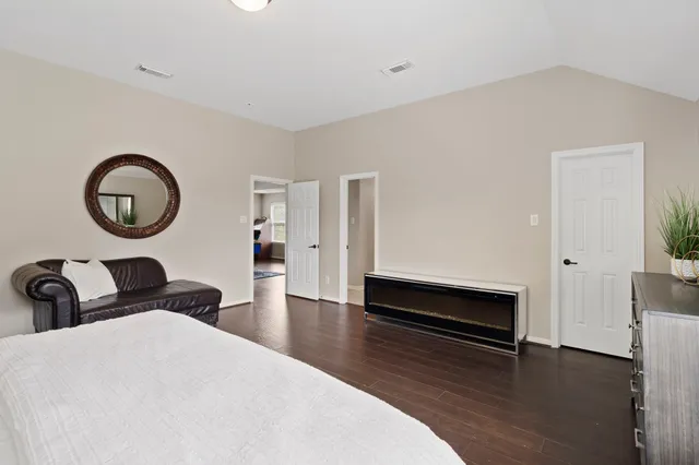 a bedroom with bed and a chair