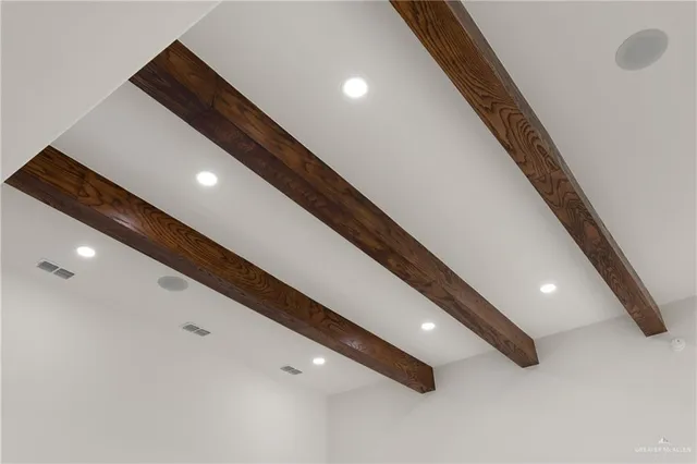 a large hall with stainless steel appliances wooden floor