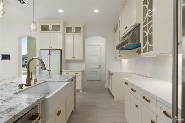 a kitchen with a sink and cabinets