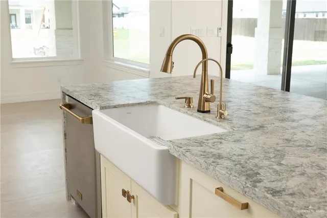 a close view of a sink a faucet and appliance in the kitchen