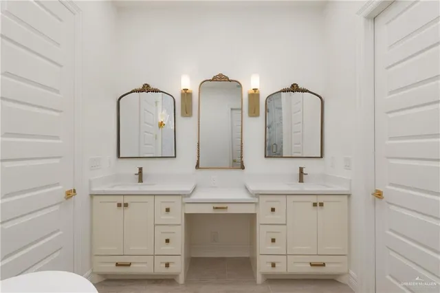 a bathroom with double vanity sink two mirror and a toilet