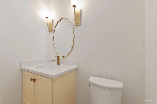 a bathroom with a sink a toilet and mirror
