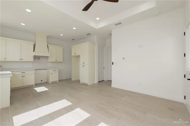 a view of a kitchen with white cabinets