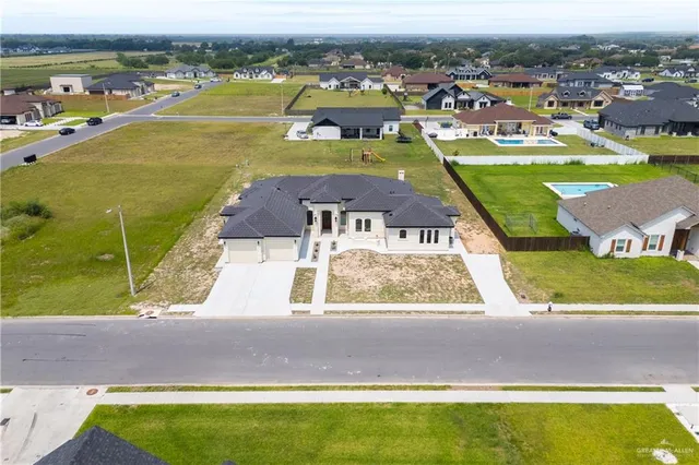an aerial view of a residential houses with outdoor space