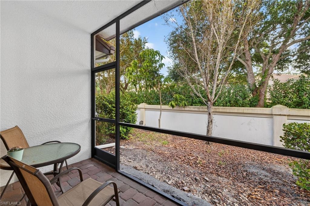 7845 Bristol Circle Naples, FL 34120 - Photo 25 of 31 a view of a chair and table in the balcony